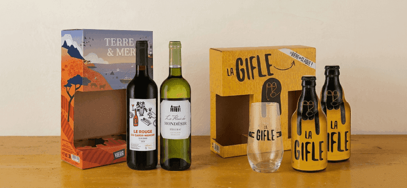 Assortment of wine and 'La Gifle' branded bottles with custom boxes and a drinking glass.