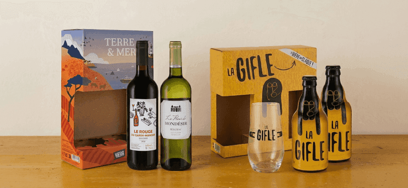 Two distinct gift sets, one with wine bottles and another with 'La Gifle' beverages and a glass.