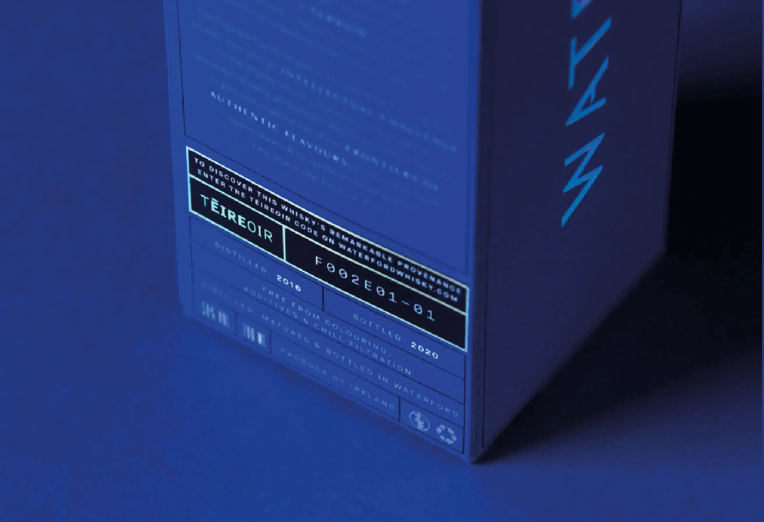 Deep blue product box featuring a white information label and light blue text on its side.