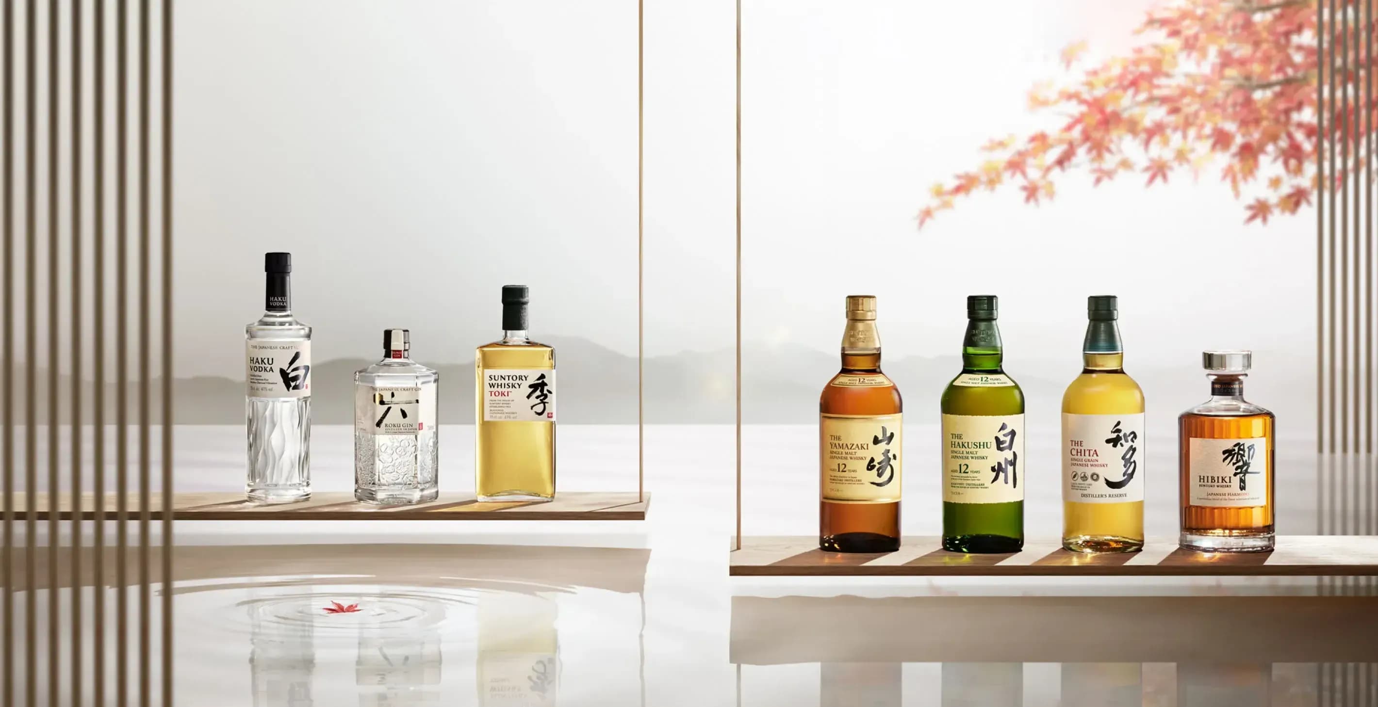 A collection of Japanese spirit bottles on display, featuring clear and amber varieties.