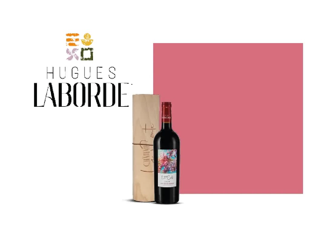 Hugues Laborde red wine bottle stands with its distinct, tall paper bag packaging.